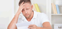 Image of a man reading about a claim